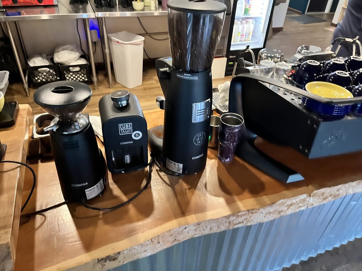 Hardwood counter surface in daily use at a coffee shop grinder station